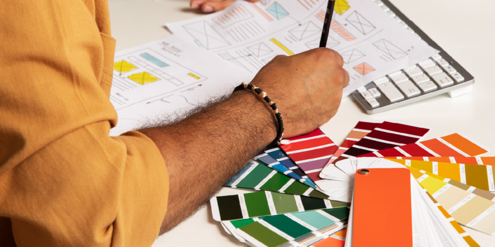 Graphic designer planning a print layout, ensuring accurate colours and branding consistency. Fast Printing Services Brisbane.