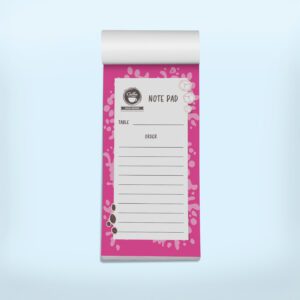 Mockup of a coffee-themed notepad with a pink design, showing sections for table number and order details, decorated with coffee beans and ice cubes.